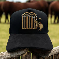 Front view of JG Hats M Rodeo Rider Black snapback cap featuring embroidered M logo with bronc rider design.