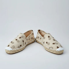 Beige slip-on shoe with pineapple pattern on a white background
