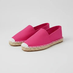 Pink espadrille shoe on a white background
