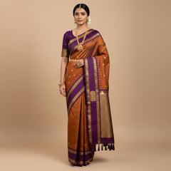 Purple and gold saree with a matching blouse on a white background