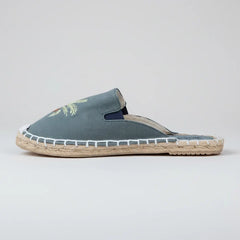 Blue espadrille slipper with jute sole on a white background