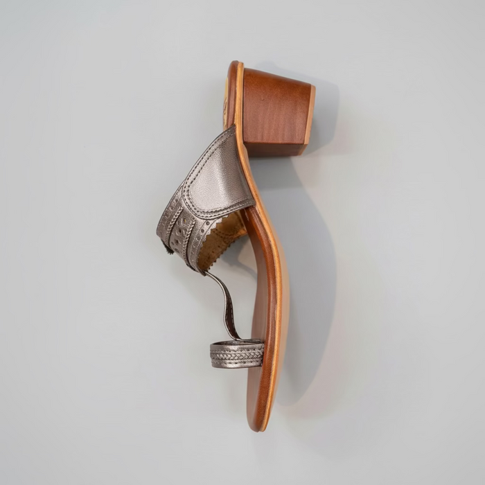 High-heeled shoe with wooden sole on a light gray background