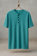 Teal short-sleeve henley shirt hanging on a wooden hook against a neutral background