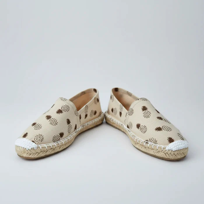 Beige slip-on shoe with pineapple pattern on a white background