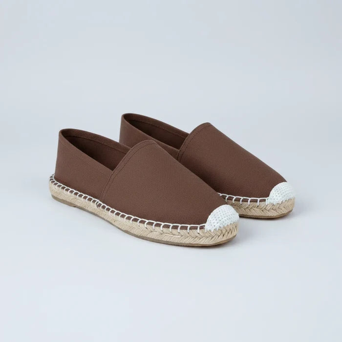 Brown slip-on shoe with white sole on a white background