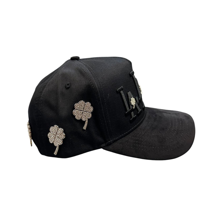 Side view of black LA streetwear snapback hat featuring silver rhinestone clover details