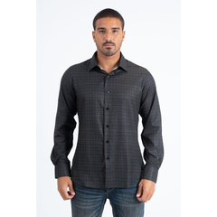 Man wearing a black and multi color long sleeve geometric print button-down shirt paired with jeans, modern men's fashion look- front view