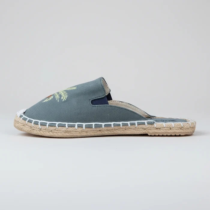 Blue espadrille slipper with jute sole on a white background